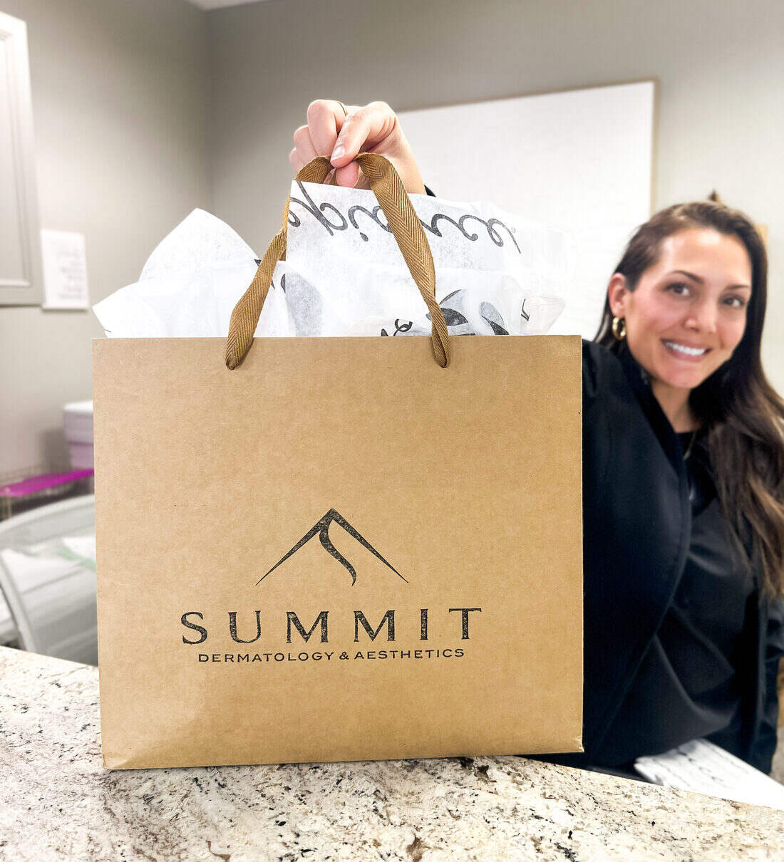 Take-home medical-grade skincare in a Summit Dermatology & Aesthetics bag