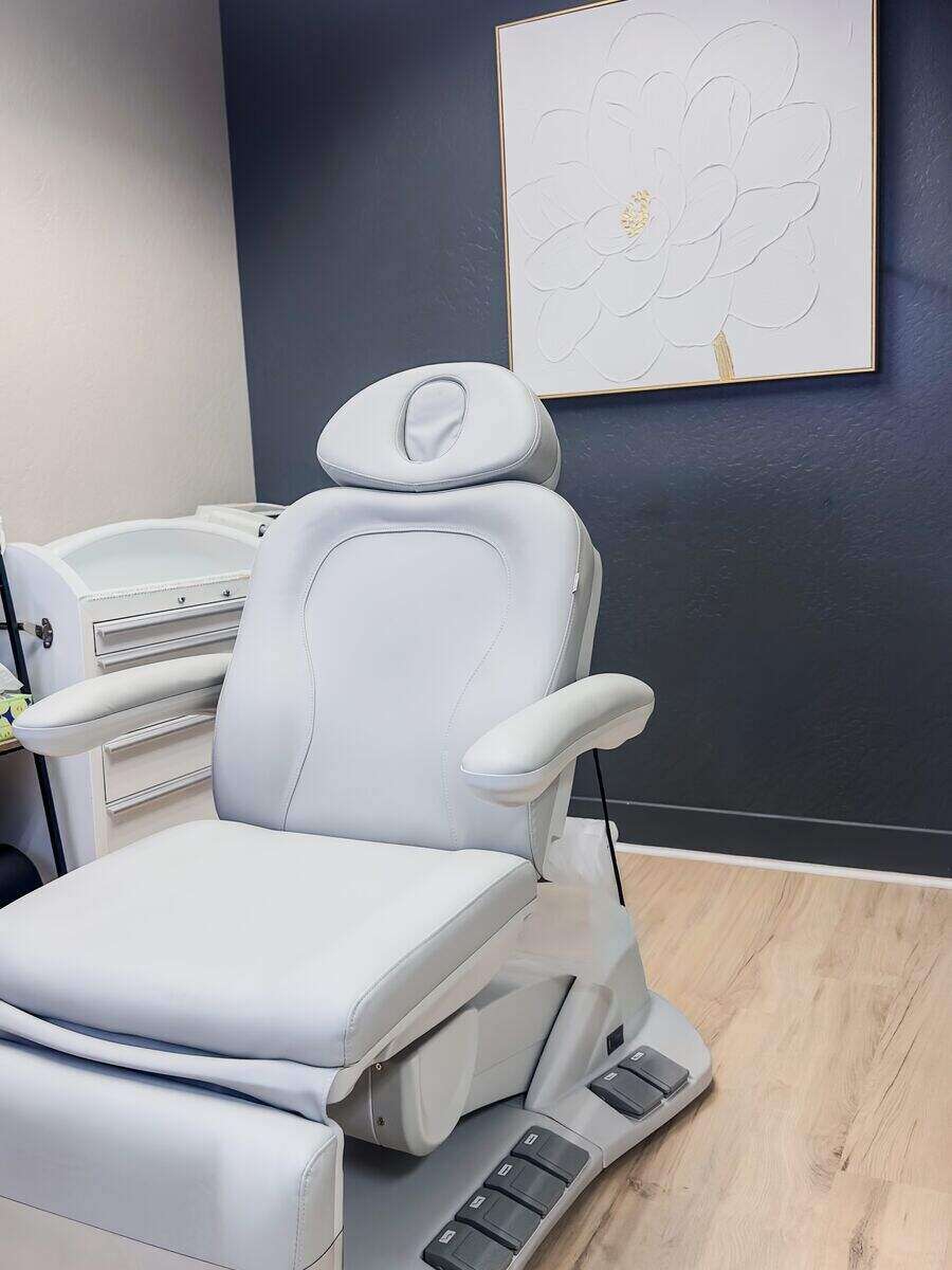 Aesthetic treatment room with a modern white treatment chair at Summit